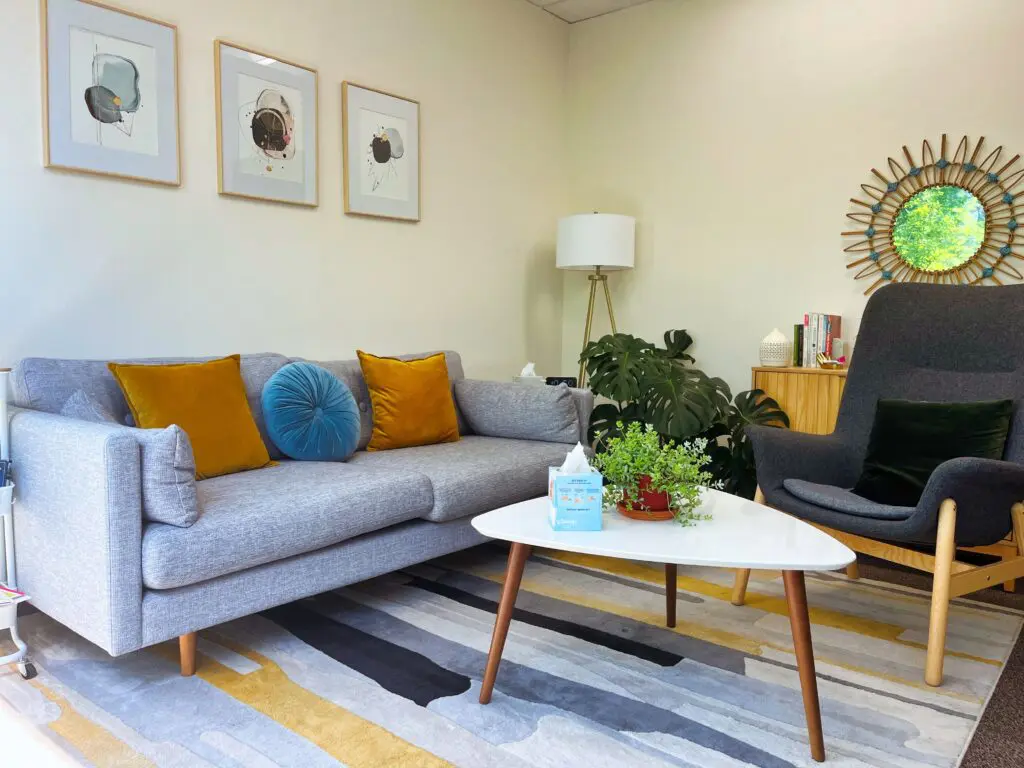 A living room with a couch, chair and table.