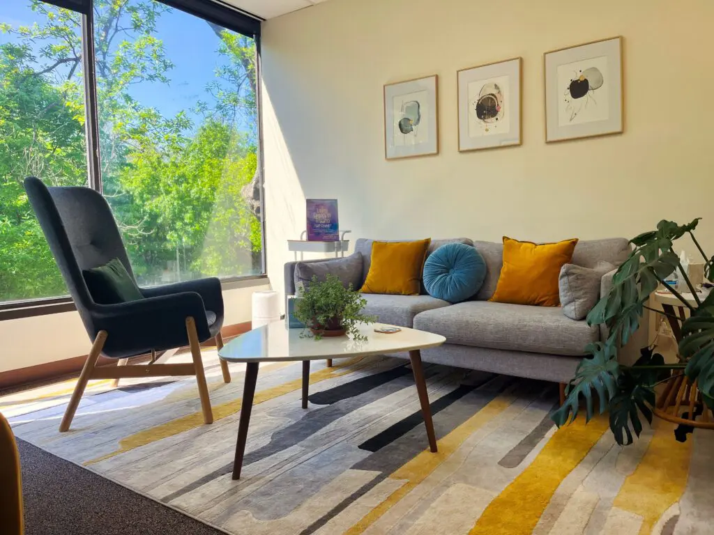 A living room with a couch, chair and table.